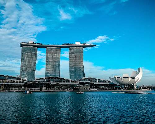 singapore gray concrete buildings near body of water blue